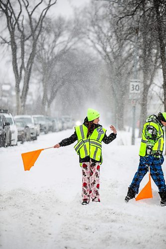 MIKAELA MACKENZIE / FREE PRESS

School patrols Mariah (left) and Oliver demonstrate what they would usually do at Isaac Brock School on Friday, Dec. 19, 2025. 

For Maggie story.
Free Press 2025