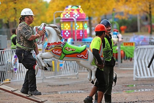 A work crew with Select Shows unloads one of 30 carousel horses during an afternoon midway set up.  (Matt Goerzen/The Brandon Sun)
