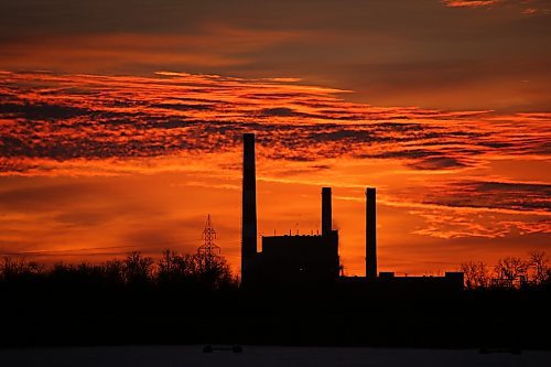 The Manitoba Hydro Brandon generating station off Victoria Avenue East is silhouetted against a colourful sky just before sunrise on the second day of 2026. (Matt Goerzen/The Brandon Sun)