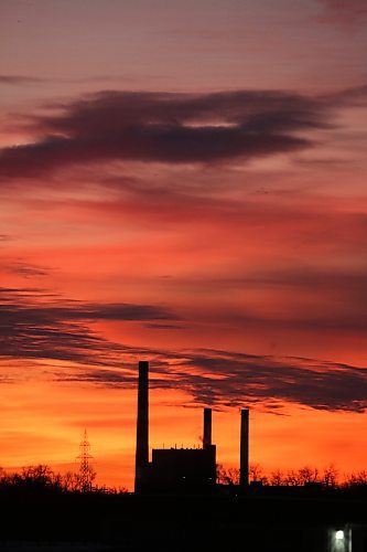 The Manitoba Hydro Brandon generating station off Victoria Avenue East is silhouetted against a colourful sky just before sunrise on the second day of 2026. (Matt Goerzen/The Brandon Sun)
