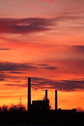 The Manitoba Hydro Brandon generating station off Victoria Avenue East is silhouetted against a colourful sky just before sunrise on the second day of 2026. (Matt Goerzen/The Brandon Sun)