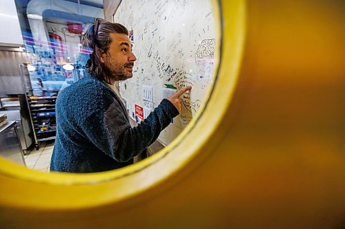MIKE DEAL / FREE PRESS
Chef Mandel Hitzer looks at the celebrity wall in the kitchen of his restaurant Deer + Almond at 85 Princess Street. 
Reporter: Malak Abas
260107 - Wednesday, January 07, 2026.