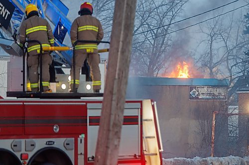 MIKE DEAL / FREE PRESS
WFPS crews work at putting out a fire at 45 Archibald Street Thursday morning.
Brad Mazer, acting district chief with WFPS, held a brief media scrum, saying they were called to the scene around 3:30 a.m. from police who were already there.
They will be dealing with the fire until close to the noon hour.
There were reports of flammable liquids, and because the fire was well involved they decided to fight it defensively.
Significant damage to the building but no official damage estimate.
No one was inside the building.
260108 - Thursday, January 08, 2026.