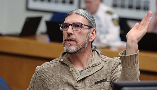 Coun. Kris Desjarlais (Ward 2) mimics a dump truck's arm while asking a question at Thursday's special council meeting. (Alex Lambert/The Brandon Sun)