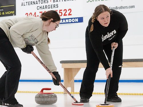 Kelsey Crandall and Jennah Derksen prepare to sweep a rock during the women's A-side championship. (Massimo De Luca-Taronno/The Brandon Sun)