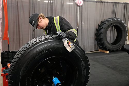 19012026
Logan Craig with Denray Tire in Brandon polishes a tire while preparing the Denray Tire booth at the Keystone Centre on Monday ahead of Manitoba Ag Days 2026. Ag Days opens today and runs until Thursday.
(Tim Smith/The Brandon Sun)