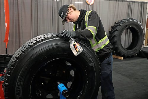 19012026
Logan Craig with Denray Tire in Brandon polishes a tire while preparing the Denray Tire booth at the Keystone Centre on Monday ahead of Manitoba Ag Days 2026. Ag Days opens today and runs until Thursday.
(Tim Smith/The Brandon Sun)