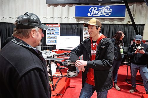 Todd Fraser with Flaman speaks with a visitor at the Flaman booth on Tuesday. (Tim Smith/The Brandon Sun)