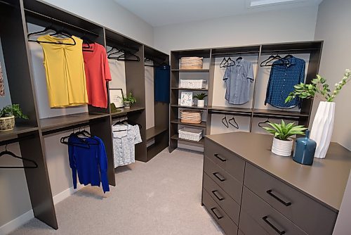 Todd Lewys / Free Press 
The primary bedroom’s walk-in closet, which comes with a storage island plus of tons of built-in storage, checks in at a spacious eight-by-10 feet.