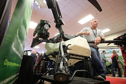 20012026
Travis Karle, President and CEO of Ag Drone Canada, leans over a Spider-i M400 agricultural drone while speaking with visitors to Ag Drone Canada’s booth at Manitoba Ag Days 2026 on Tuesday. 
(Tim Smith/The Brandon Sun)