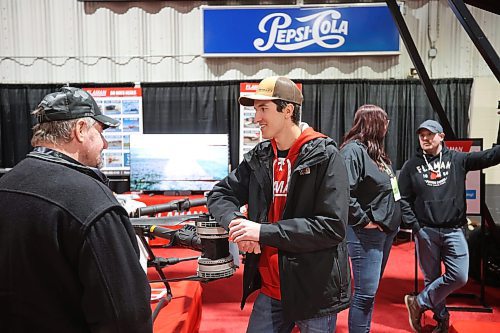 20012026
Todd Fraser with Flaman speaks with a visitor to Manitoba Ag Days 2026 about the uses for a DJI Agras T100 drone on display at the Flaman booth on Tuesday. 
(Tim Smith/The Brandon Sun)