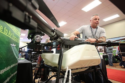 20012026
Travis Karle, President and CEO of Ag Drone Canada, leans over a Spider-i M400 agricultural drone while speaking with visitors to Ag Drone Canada’s booth at Manitoba Ag Days 2026 on Tuesday. 
(Tim Smith/The Brandon Sun)