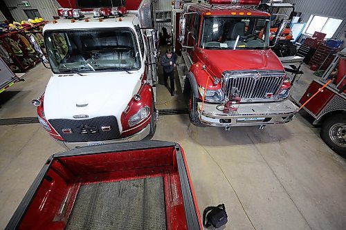 Health and safety are the primary reasons that the Virden fire station is being remodelled, said chief Cory Nixon. Nixon is seen running between two trucks. He demonstrated how the tight space in the hall leads to difficulty for firefighters loading into trucks, such as the car doors opening into each other, and the issue of suits tearing when firefighters are crossing small passage ways between two trucks. (Connor McDowell/The Brandon Sun)