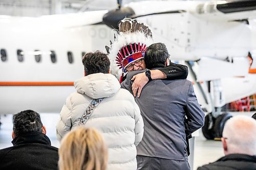 MIKAELA MACKENZIE / FREE PRESS

Pimichikimak Cree Nation chief David Monias hugs Todd Merrick at the Perimeter Aviation announcement of the dedication of its newest Dash 8 aircraft  to the late Cathy Merrick on Wednesday, Jan. 28, 2026.

For Malak story.
Free Press 2026