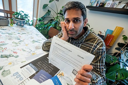 JOHN WOODS / WINNIPEG FREE PRESS
Jeremy Dias, who is looking at his recent city property assessment which states that his home has gone up $193,000 from the last assessment, is photographed in his home Tuesday, February 3, 2026. 

reporter: joyanne