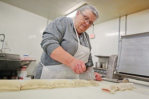 Baker Shelly Hillis cuts sausage rolls on Wednesday afternoon for the Westman Multicultural Festival’s Scottish pavilion, which opens on Friday evening. Henry Meats has been involved in food preparation for Brandon’s Scottish pavilion since the festival began. (Matt Goerzen/The Brandon Sun)