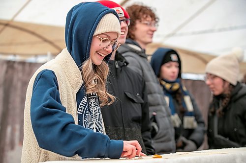 BROOK JONES/FREE PRESS
Chloe Zirk, 18, (left) is pictured rolling frozen maple taffy on a stick in the Sugar Shack on the final day of the 57th edition of Festival du Voyageur in Saint Boniface, Man., Sunday, Feb. 22, 2026.