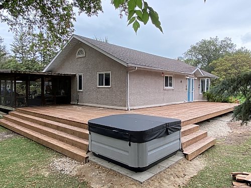 Marc LaBossiere / Free Press
On a treated-lumber double-wing deck-build project, one section of top decking is completed before railing and fascia are applied.