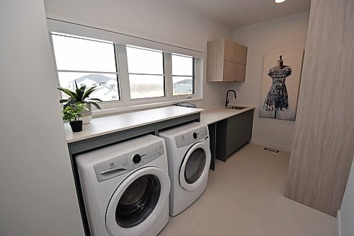 Todd Lewys / Free Press
There’s tons of space to clean clothes in the second-floor laundry room amid loads of natural light and luxurious finishes such as Dexton countertops and a rich tile floor.