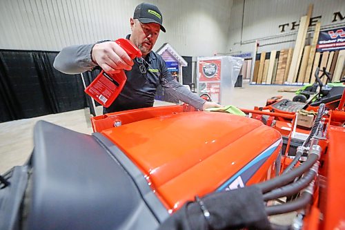 Frank Remple with battery company Greenworks Commercial helps shine up a Kioti front-end loader from South Korea on Thursday afternoon at the Keystone Centre, as a favour to Virden Ag owner Matt Hipwell, which now carries Greenworks products. The two businessmen are participants in the Brandon Home and Leisure Show, which starts today. The three-day event is a must-see for anyone looking for home renovation and residential improvement ideas, and includes free family entertainment, a golf simulator, and a speaker series. (Matt Goerzen/The Brandon Sun)