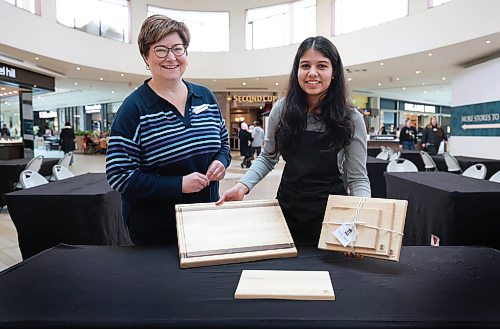 Ruth Bonneville Winnipeg Free Press 

Biz Student Trade Fair

Junior Achievement student, Tasvee Jain, shows off her Luxury Prep cutting boards she made through JA, with program manager, Jeanette Bergmann, for  the upcoming student trade fair at St. Vital centre Friday. 
The JA Trade Fair is where High school students with JA will share their business pitches in the centre court at St. Vital mall Saturday.

MALAK

March 6th,, 2026
