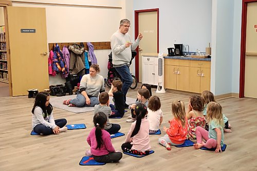 Children ages three to six listened to instructor Robert Richardson snap his fingers to make a rhythm during the first lesson of a new violin program offered at the Brandon Public Library on Friday. (Tessa Adamski/ The Brandon Sun)