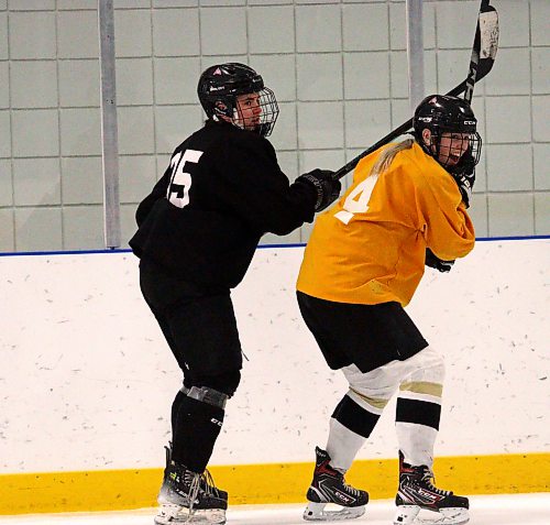 Victoria Mann of the Assiniboine College Cougars battles for ice with teammate Jenna Walker during 3-on-3 practice at the Sportsplex on Monday night. Her team will head to St. Louis on Friday for the American Collegiate Hockey Association women's Division 2 national tournament, which goes from Sunday to Thursday. (Massimo De Luca-Taronno/The Brandon Sun)