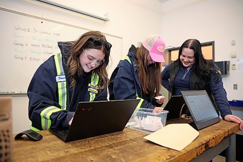 Elle McMullen (left) and Andrixe Tremblay (second from left) with École Saint-Lazare compete to find machinery technical information using the CNH AI Tech Assist program while learning about Assiniboine College’s Heavy Equipment Technician program as Courtney Matienzo with Mazergroup looks on. (Tim Smith/The Brandon Sun)