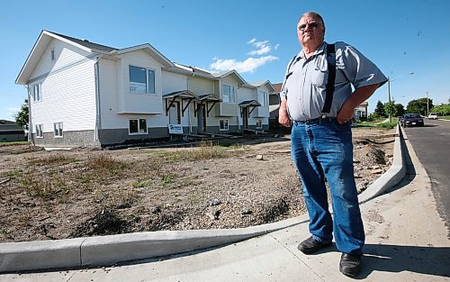 Arnold Grambo, pictured here in 2008 standing outside a new Habitat for Humanity build, was a major housing advocate with Habitat and later for Brandon Community Builders. Grambo died on March 22 at age 85. (Bruce Bumstead/The Brandon Sun files)