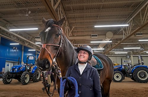 Zoe Gerein stands alongside her horse Lily as they prepare for a jumper competition at the Keystone Centre in Brandon. On Tuesday, March 31 (Weichen Zhang / The Brandon Sun)