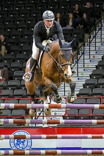 Sergey Zayika rides his horse, O'Marly, during the Wawanesa Insurance Accumulator horse jumping competition at the Royal Manitoba Winter Fair at Assiniboine Credit Union Place on Monday evening. (Thomas Friesen/The Brandon Sun)