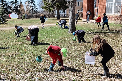 Some children pick eggs across the lawns of Assiniboine College’s North Hill Campus for the college’s annual Easter Eggstravaganza Saturday afternoon. (Abiola Odutola/The Brandon Sun)