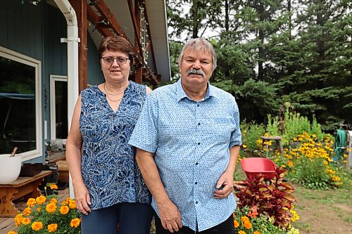 Janice Allen and her husband, Gerald, stand in front of their home in the RM of Cornwallis last summer. Afte being scammed last summer, the couple recently found more than $4,000 of fraudulent activity on their credit card. (Abiola Odutola/The Brandon Sun files)