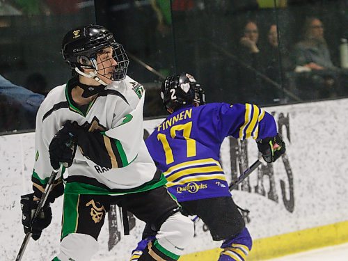 Blades forward Kaelen Finnen (17) dances around Raiders forward Nash Hutson (7) along the boards. (Massimo De Luca-Taronno/The Brandon Sun)