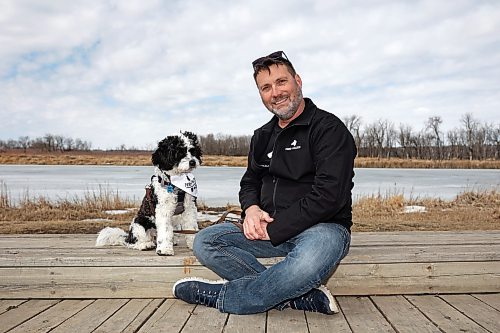 Canadian Armed Forces veteran Joel Langley, co-founder of Paws 4 Valour, sits with his dog, Bandit, at Dinsdale Park in Brandon on Friday afternoon. The program's upcoming session had an “overwhelming response,” Langley said. (Tim Smith/The Brandon Sun)