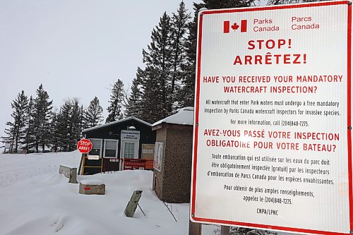 Dated signage about watercraft inspections for invasive species including zebra mussels is posted at Clear Lake’s boat cove in Riding Mountain National Park on Wednesday. (Tim Smith/The Brandon Sun)