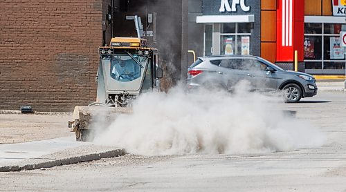 MIKE DEAL / FREE PRESS
A water truck and a sidewalk cleaner work their way through the Point Road neighbourhood Thursday afternoon.
260423 - Thursday, April 23, 2026.