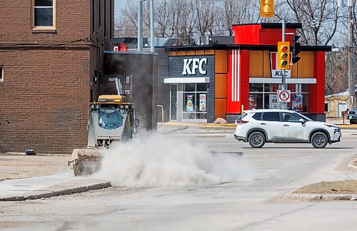 MIKE DEAL / FREE PRESS
A water truck and a sidewalk cleaner work their way through the Point Road neighbourhood Thursday afternoon.
260423 - Thursday, April 23, 2026.