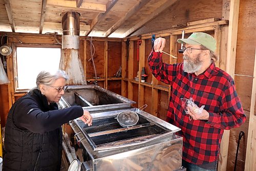 Gina Nepinak (left), a teacher with the Brandon Friendship Centre Reconnections to OUR Culture program’s Anishinaabemowin class, samples maple sap at the sugar shack Dave Barnes runs in conjunction with the Brandon Food Forest at his property in Brandon’s east end on Thursday. Although not boiled down into syrup yet, the sap already has a distinctly sweet taste. See more photos on Page A4. (Tim Smith/The Brandon Sun)