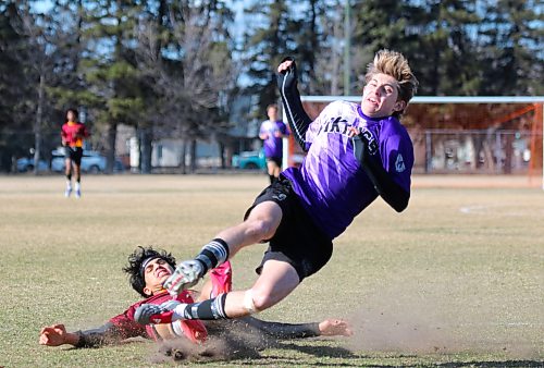 Crocus Plainsmen Mohamad Alabeid completes a successful slide tackle, taking Vincent Massey forward Jaxson Brick down in the process during their Brandon High School Soccer League season opener at Massey on Monday. (Thomas Friesen/The Brandon Sun)