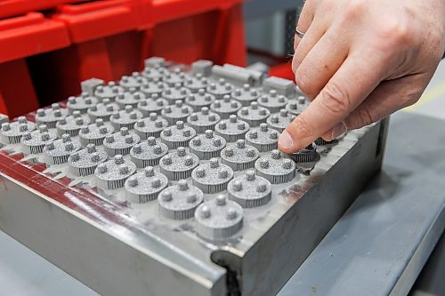 MIKE DEAL / FREE PRESS
Martin Petrak, President of Precision ADM, lifts a box cover to reveal a tray of 3D printed kneecaps that are headed to the finishing area of the production line.
Precision ADM is a global engineering and manufacturing solutions provider that uses Additive Manufacturing, also known as 3D Printing, as a core technology, complemented by multi-axis machining to manufacture high value components and devices for the medical, aerospace, energy, and industrial sectors.
Reporter: Aaron Epp
260424 - Friday, April 24, 2026.