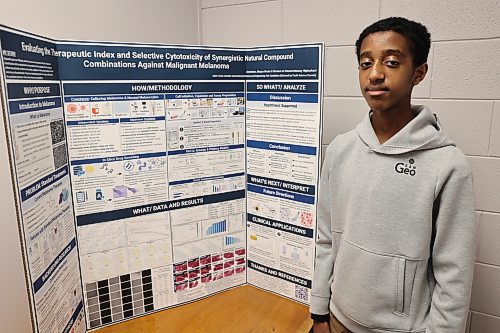 Vincent Massey High School grade 9 student Abereham Moges stands by his project, 'Selective Synergy in Melanoma Drugs' in the school on Friday afternoon. Moges was named Best of Fair at the 56th annual Western Manitoba Science Fair (WMSF) last month and received an all-expenses-paid trip to represent Western Manitoba at the Canada Wide Science Fair 2026 in Edmonton from May 23 to 30. (Abiola Odutola/The Brandon Sun)