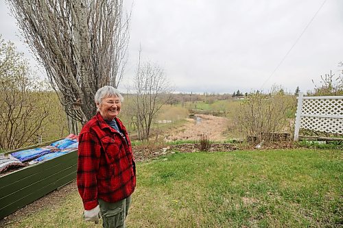 Mary Petersen, a Souris resident, is seen at a plot of grass that peacocks turned into a summer lounge for several years in her background. Petersen said she’s a bit sad to see them not spend so much time there anymore. (Connor McDowell/The Brandon Sun)