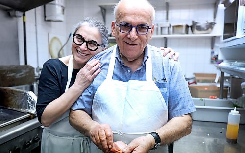 Ruth Bonneville Free Press
BIZ - Pappas closing after 50 years
Photo of Bob and Maria Papasotiriou, sharing a quick embrace on their last day of business Friday.
After 50 years serving the community at 3318 Roblin Blvd., Bob and Maria Papasotiriou are retiring and closing Pappas Greek Food.
Story by Aaron.
May 22nd,, 2026