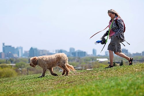 Ruth Bonneville  Free Press

Standup - Dog walker 

Heike Eidse walks her 11-year-old Australian labradoodle, Finnegan, along the crest of Westview Park (Garbage Hill) on a sunny Monday afternoon, with the blooming Winnipeg skyline in the background.

May 25th,, 2026
