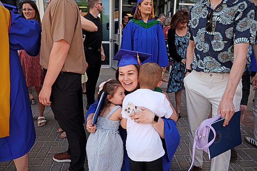 Ashley Lemus gets hugs from her daughter, Rosalee, and son, Jake, after Brandon University’s 2026 convocation for the Faculty of Health Studies at the BU Healthy Living Centre on Friday. Lemus earned her masters of psychiatric nursing degree. (Tim Smith/The Brandon Sun)