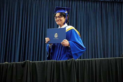 Cesar Andres Santos Espinoza holds up his degree after receiving it during Brandon University’s 2026 convocation on Thursday. Espinoza graduated from the three-year bachelor of science program. (Tim Smith/The Brandon Sun)