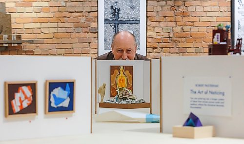 MIKE DEAL / FREE PRESS
Robert peeks over his Miniature K+G gallery which is 1/12th scale and includes a 3D printed model of Robert looking at his art.
Robert Pasternak whose show, The Art of Noticing, has been on display at the Katie and Gunner Gallery for most of May and has been extended into June.
Reporter: Jen Zoratti
260529 - Friday, May 29, 2026.