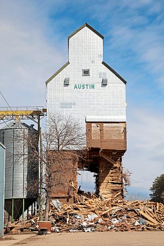 15042026
The grain elevator in Austin, Manitoba, built in 1951, is demolished by members of Pine Creek Hutterite Colony on Wednesday as a crowd looks on. The colony bought the elevator from Viterra in 2003. (Tim Smith/The Brandon Sun)