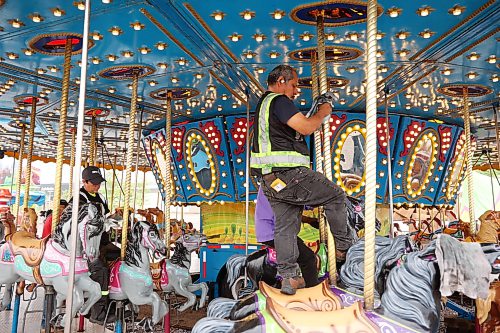 01062026
Midway workers polish the carousel ride in preparation for the 2026 Manitoba Summer Fair at the Keystone Centre grounds on Monday. The fair opens Wednesday and runs until Sunday.
(Tim Smith/The Brandon Sun)